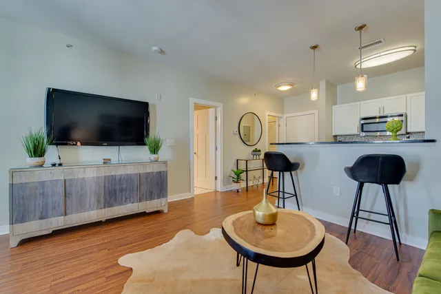 a bathroom with a granite countertop toilet sink and mirror