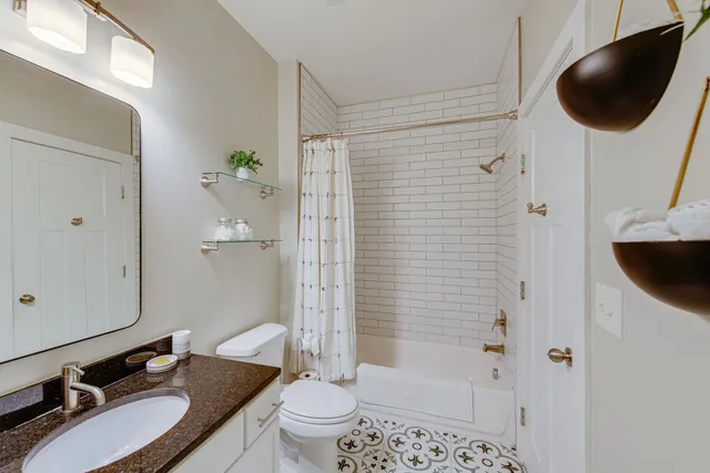 a bathroom with a white bathtub and a shower