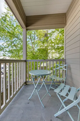 a view of a deck with wooden floor and fence next to a yard
