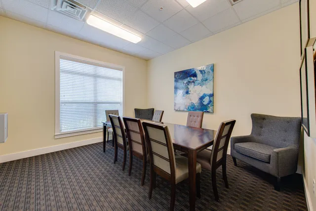 a room with lots of chairs and mirrors