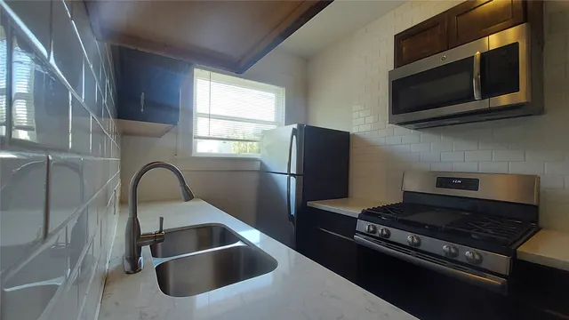 a kitchen with a stove and a microwave
