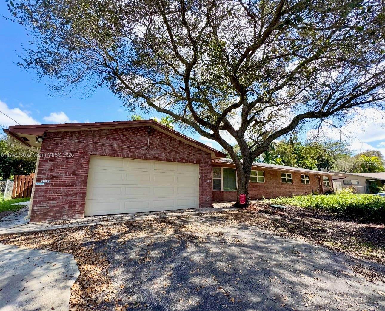 a large tree in front of a house