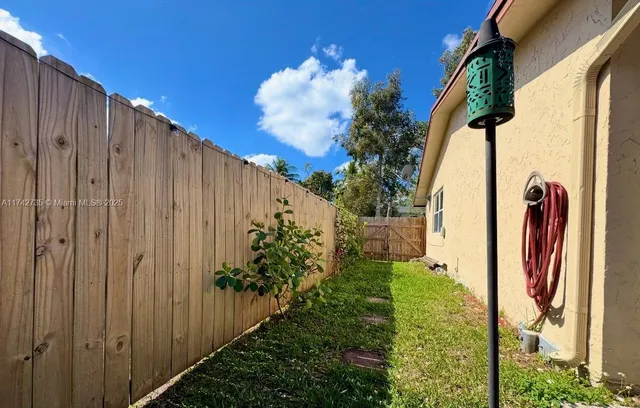 a view of a backyard with pathway