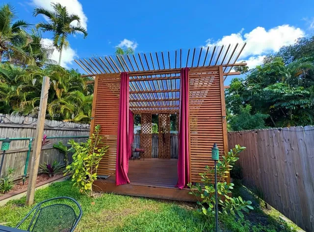 a view of a house with a porch and furniture