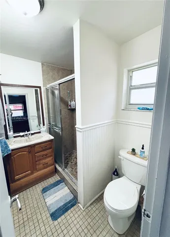 a bathroom with a toilet a sink and a shower