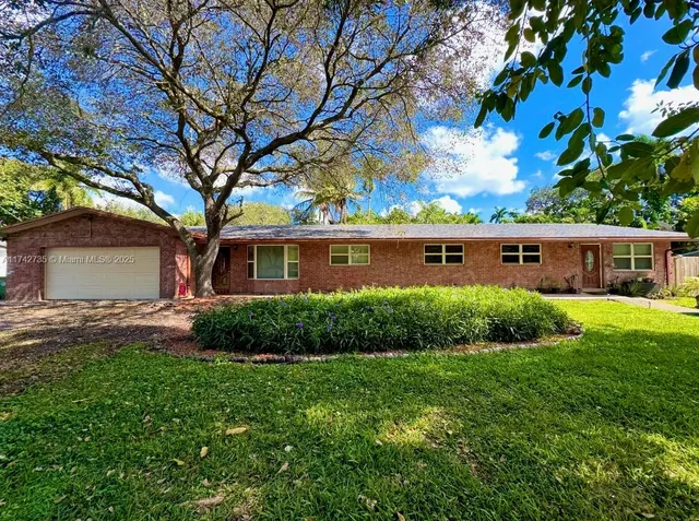 a view of house with yard