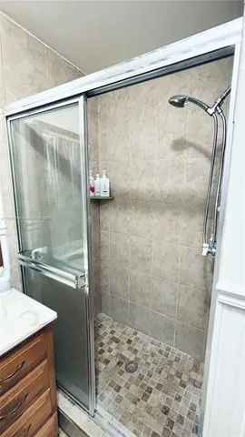 a bathroom with a shower and a sink