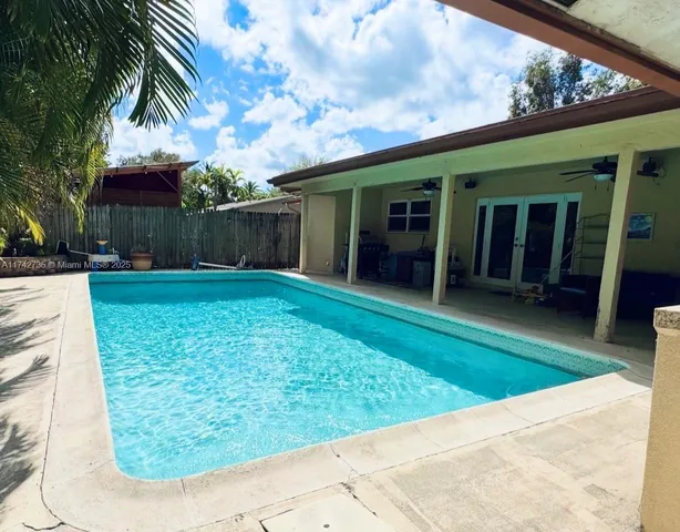 a wooden bench sitting in front of a building