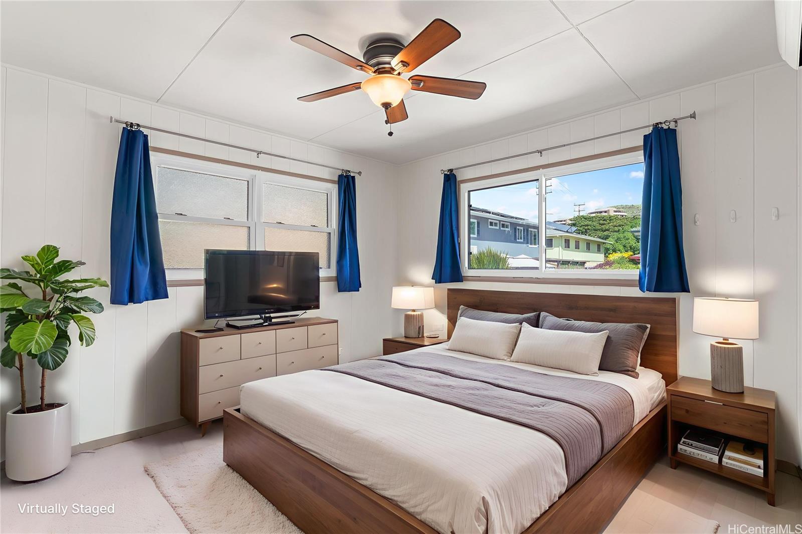 2915 Koali Road, Unit C Honolulu, HI 96826 - Photo 13 of 24 a bedroom with a bed and a flat screen tv