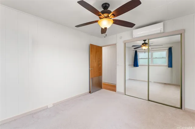 en empty room with fan and ceiling fan