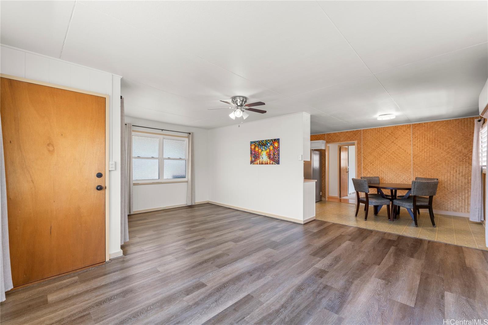 2915 Koali Road, Unit C Honolulu, HI 96826 - Photo 5 of 24 an empty room with wooden floor and furniture