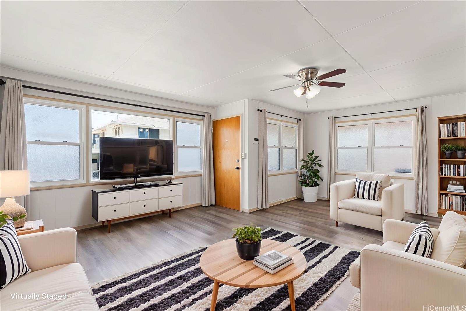 2915 Koali Road, Unit C Honolulu, HI 96826 - Photo 6 of 24 a living room with furniture and a flat screen tv