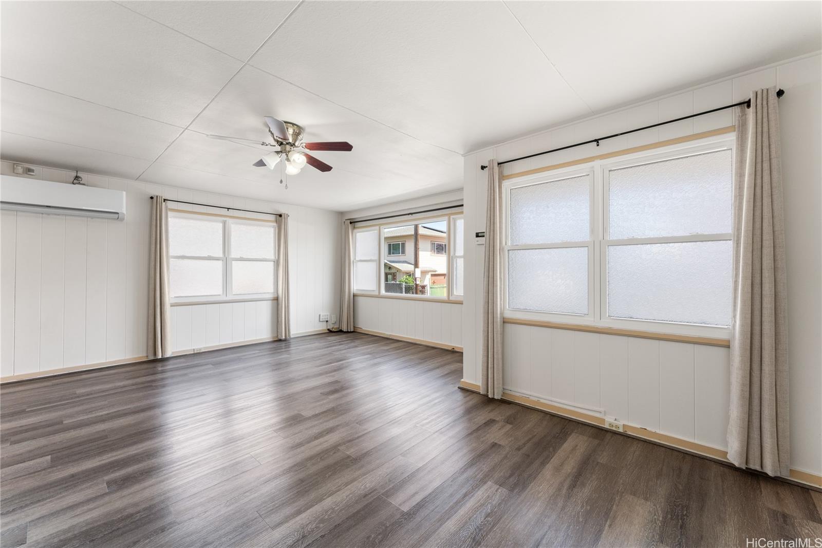 2915 Koali Road, Unit C Honolulu, HI 96826 - Photo 8 of 24 an empty room with wooden floor and windows