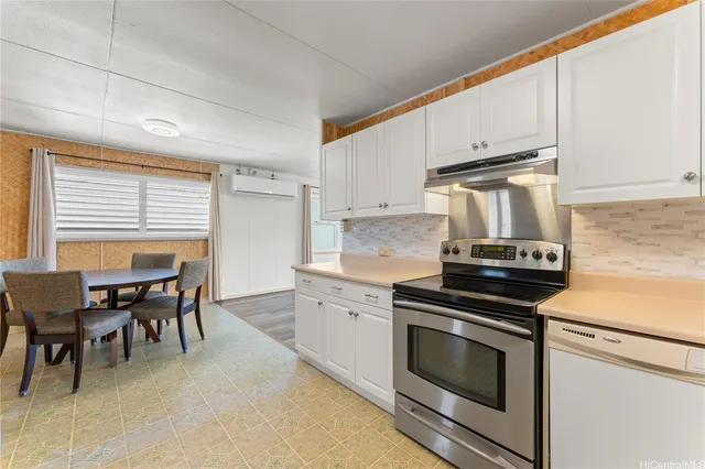 a kitchen with a stove and white cabinets