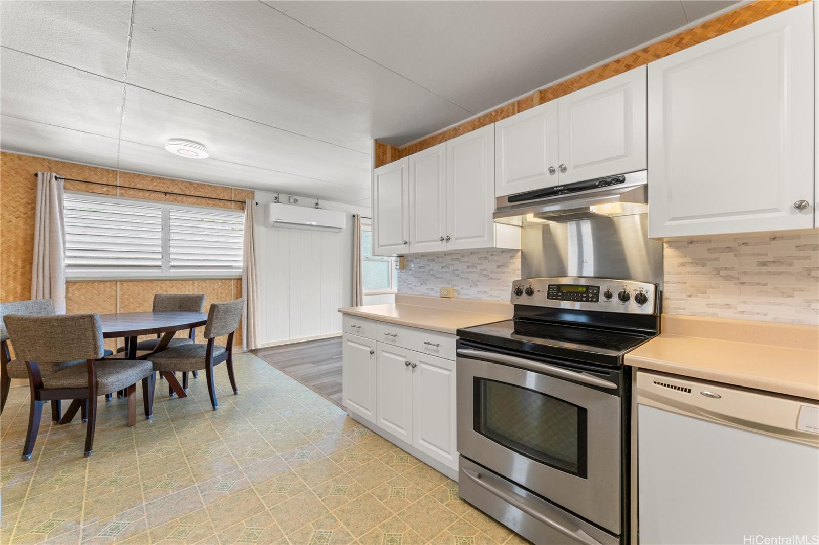 2915 Koali Road, Unit C Honolulu, HI 96826 - Photo 10 of 24 a kitchen with a stove and white cabinets