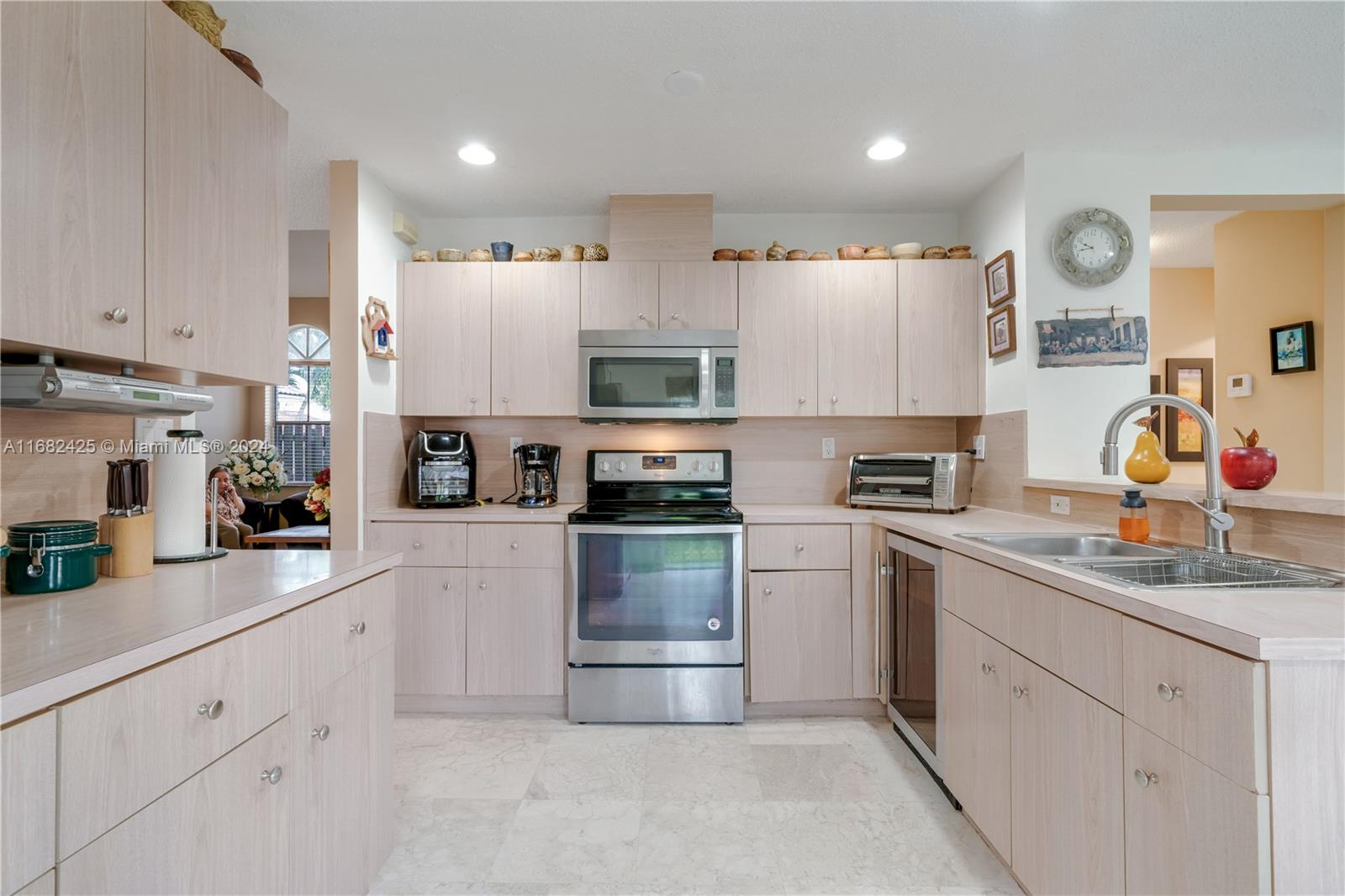 16358 Southwest 82nd Terrace Miami, FL 33193 - Photo 11 of 37 a kitchen with granite countertop white cabinets and stainless steel appliances