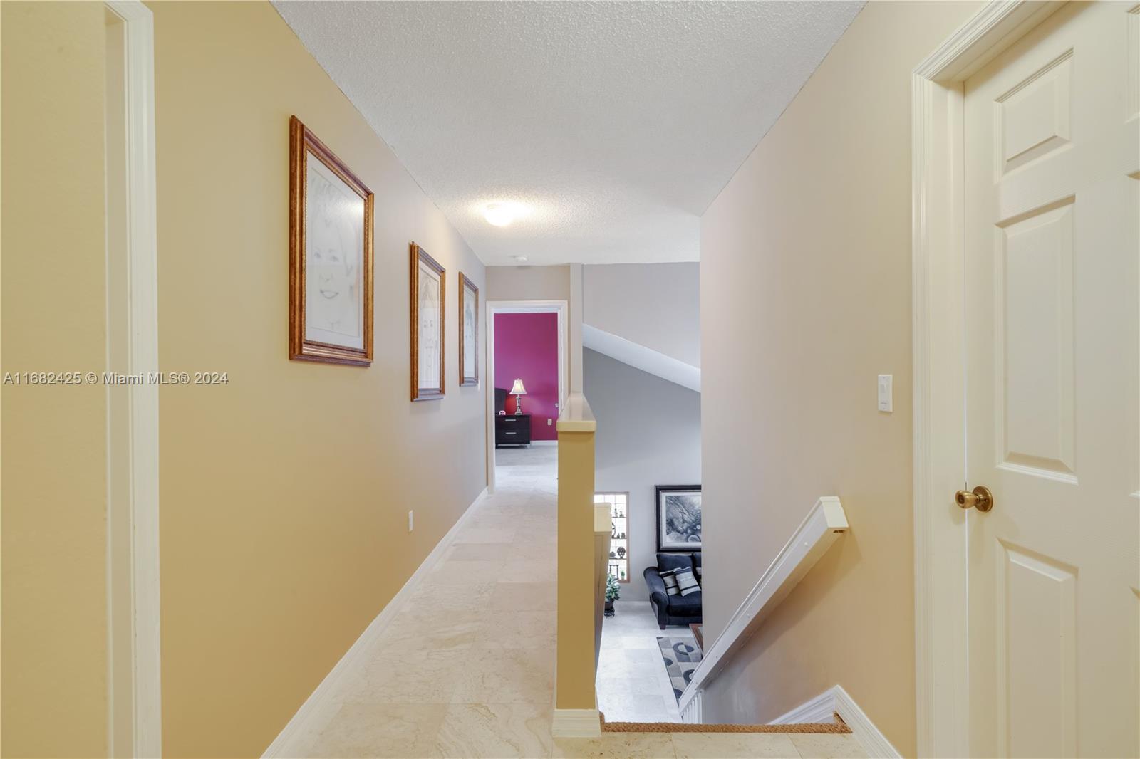 16358 Southwest 82nd Terrace Miami, FL 33193 - Photo 19 of 37 a hallway with front door windows and stairs