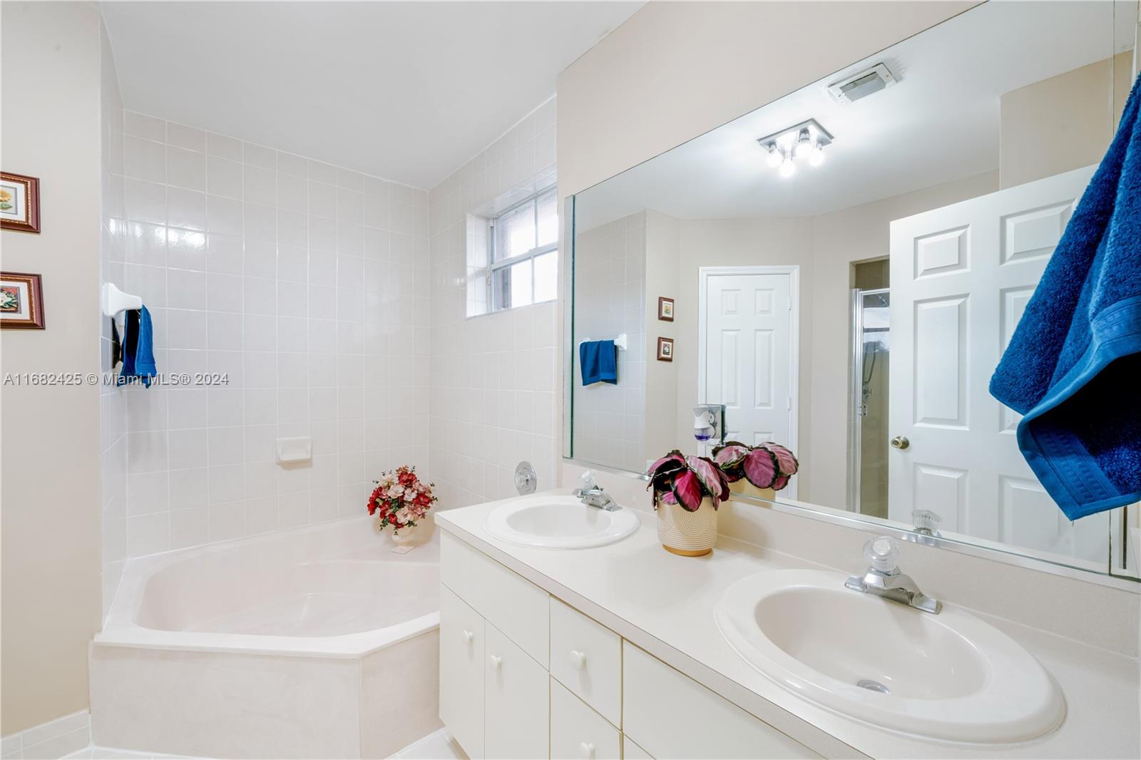 16358 Southwest 82nd Terrace Miami, FL 33193 - Photo 23 of 37 a bathroom with a tub sink and mirror
