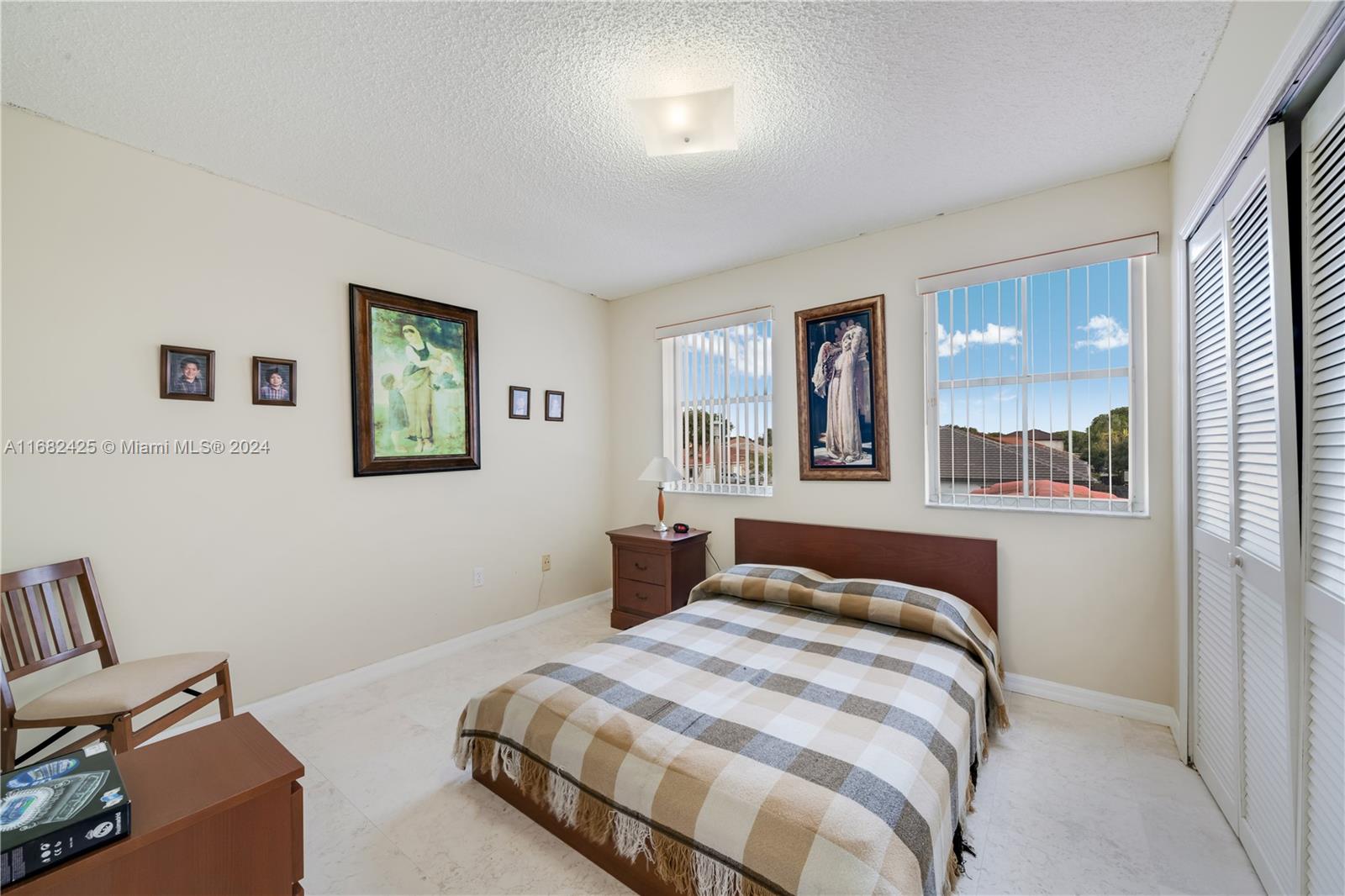 16358 Southwest 82nd Terrace Miami, FL 33193 - Photo 26 of 37 a bedroom with a bed and window