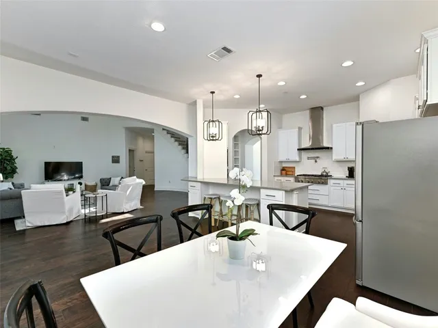 a large kitchen with kitchen island a dining table and chairs