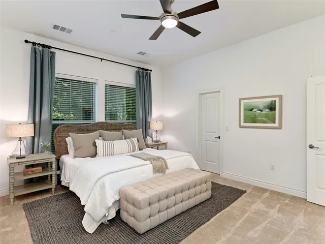 a bedroom with a large bed and a window