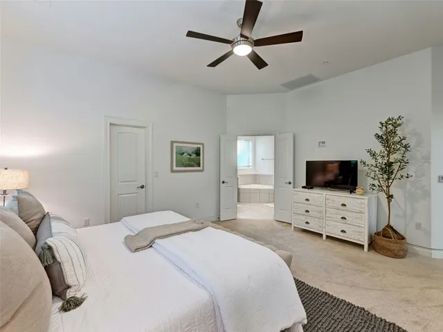 a bedroom with a bed window and a flat screen tv