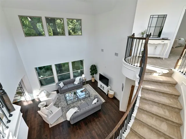 a view of living room with furniture and a floor to ceiling window