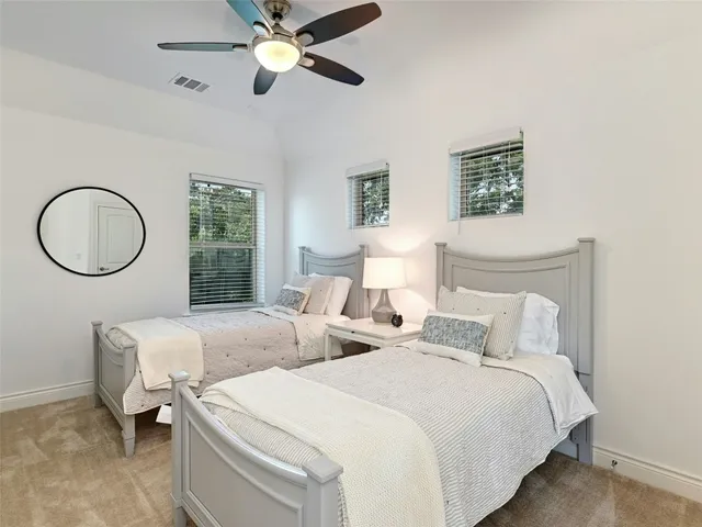 a bedroom with bed and a chandelier
