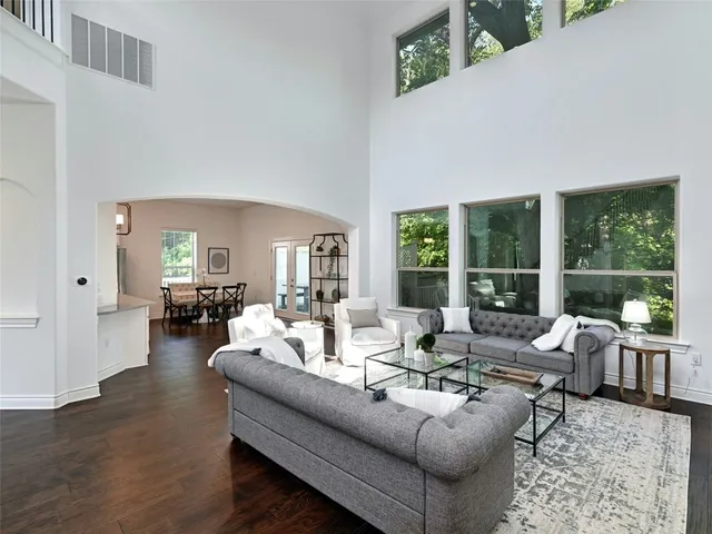 a living room with furniture and large windows
