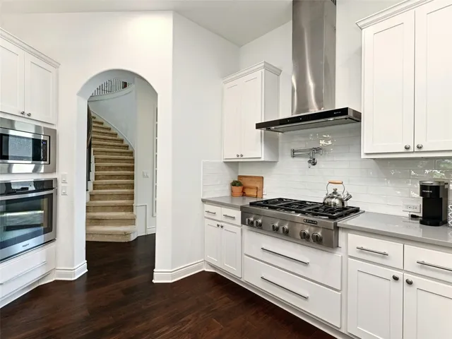 a kitchen with cabinets and appliances