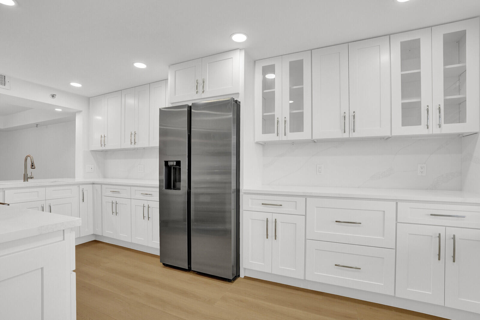 9260 Southwest 14th Street, Unit 2508 Boca Raton, FL 33428 - Photo 11 of 49 a kitchen with white cabinets and stainless steel appliances