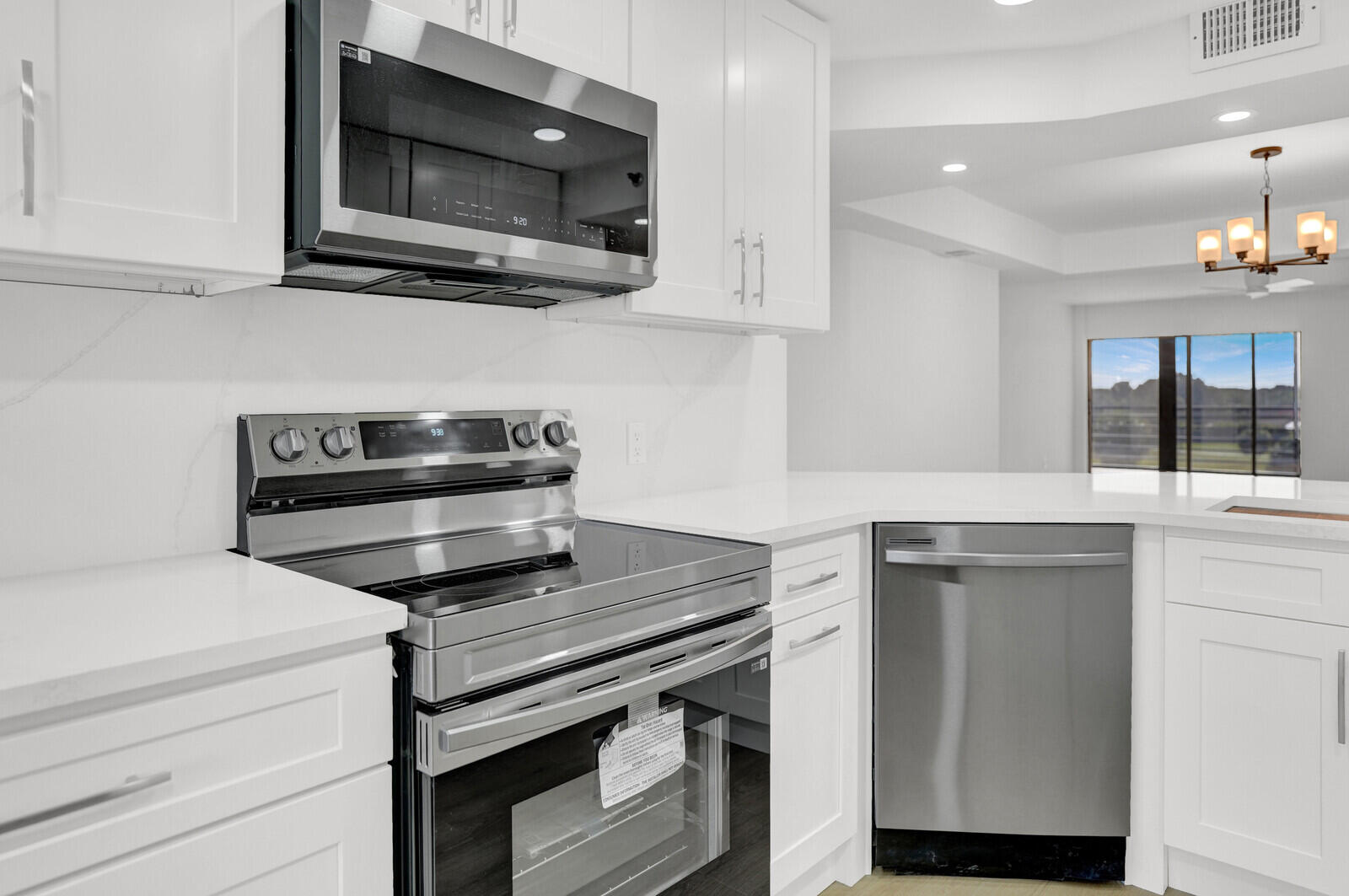9260 Southwest 14th Street, Unit 2508 Boca Raton, FL 33428 - Photo 12 of 49 a kitchen with a stove and a microwave