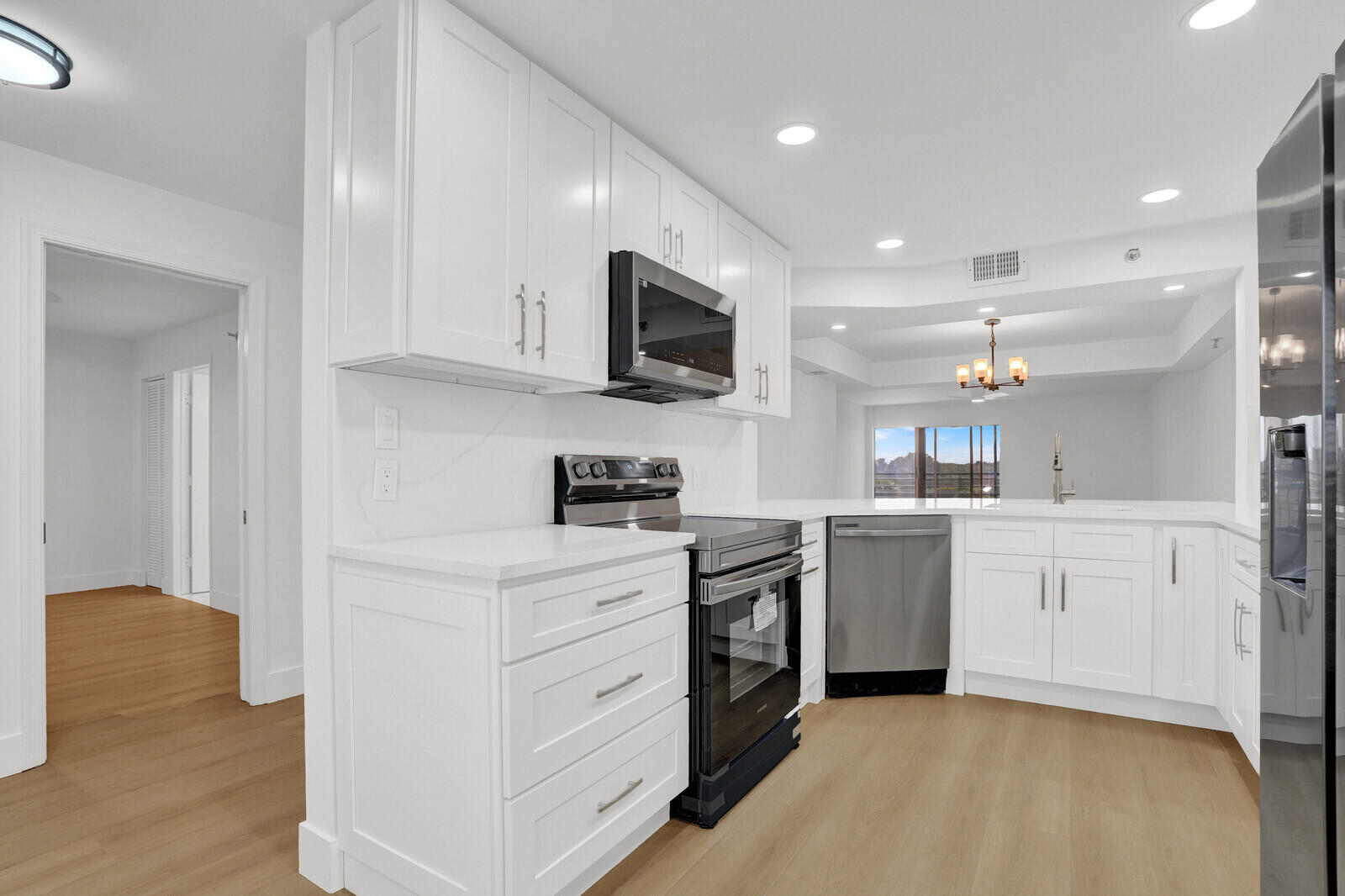 9260 Southwest 14th Street, Unit 2508 Boca Raton, FL 33428 - Photo 15 of 49 a kitchen with white cabinets and stainless steel appliances