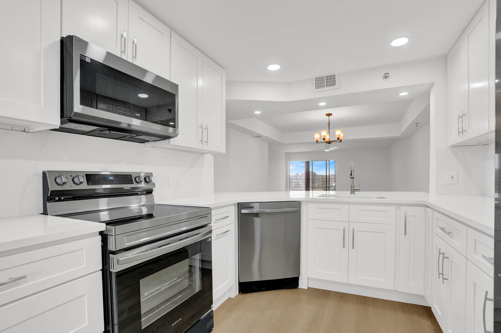 9260 Southwest 14th Street, Unit 2508 Boca Raton, FL 33428 - Photo 16 of 49 a kitchen with stainless steel appliances a stove microwave and sink