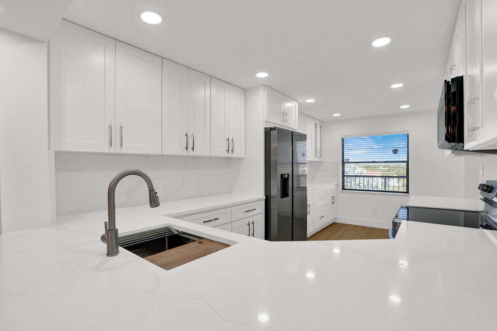 9260 Southwest 14th Street, Unit 2508 Boca Raton, FL 33428 - Photo 18 of 49 a large kitchen with stainless steel appliances a microwave a sink a stove and a refrigerator