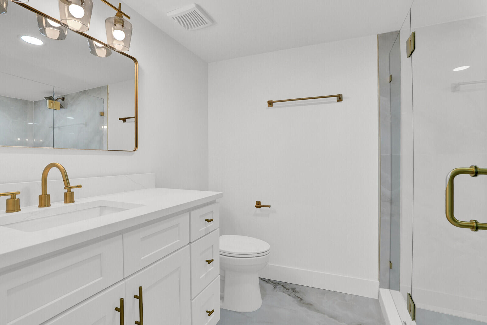 9260 Southwest 14th Street, Unit 2508 Boca Raton, FL 33428 - Photo 21 of 49 a bathroom with a granite countertop sink a toilet and a mirror