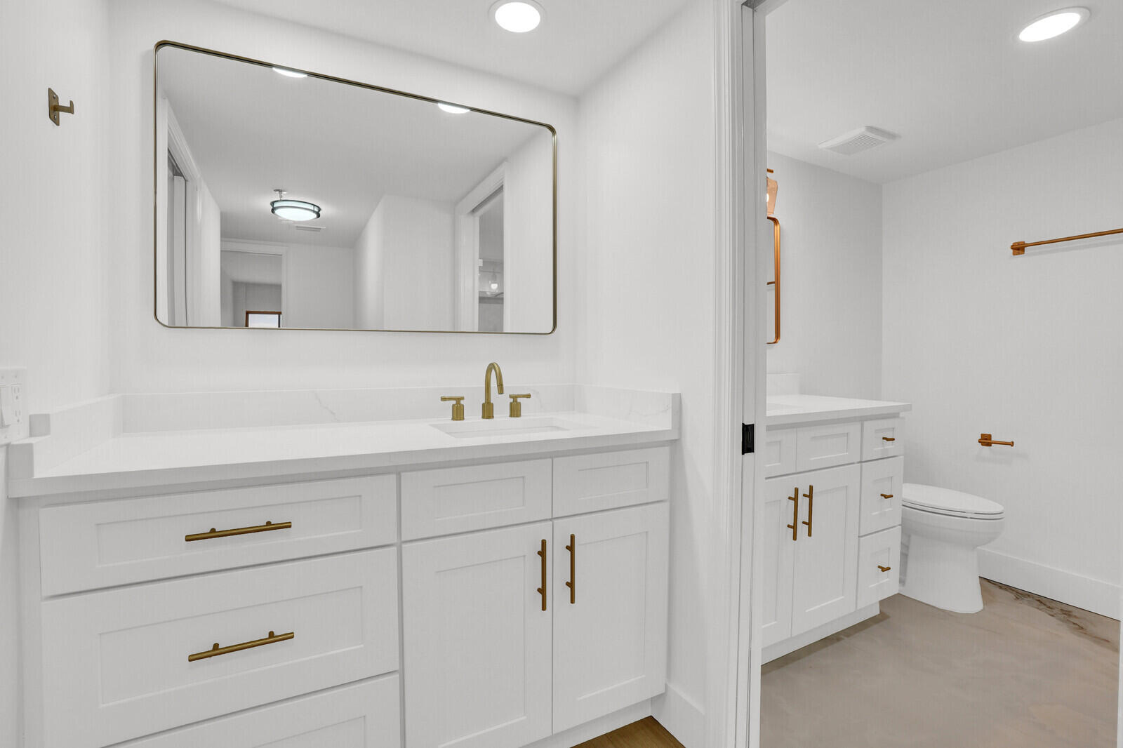 9260 Southwest 14th Street, Unit 2508 Boca Raton, FL 33428 - Photo 24 of 49 a bathroom with a toilet a sink a mirror and vanity