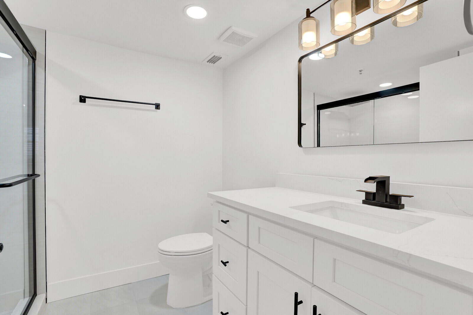 9260 Southwest 14th Street, Unit 2508 Boca Raton, FL 33428 - Photo 31 of 49 a bathroom with a toilet sink and mirror