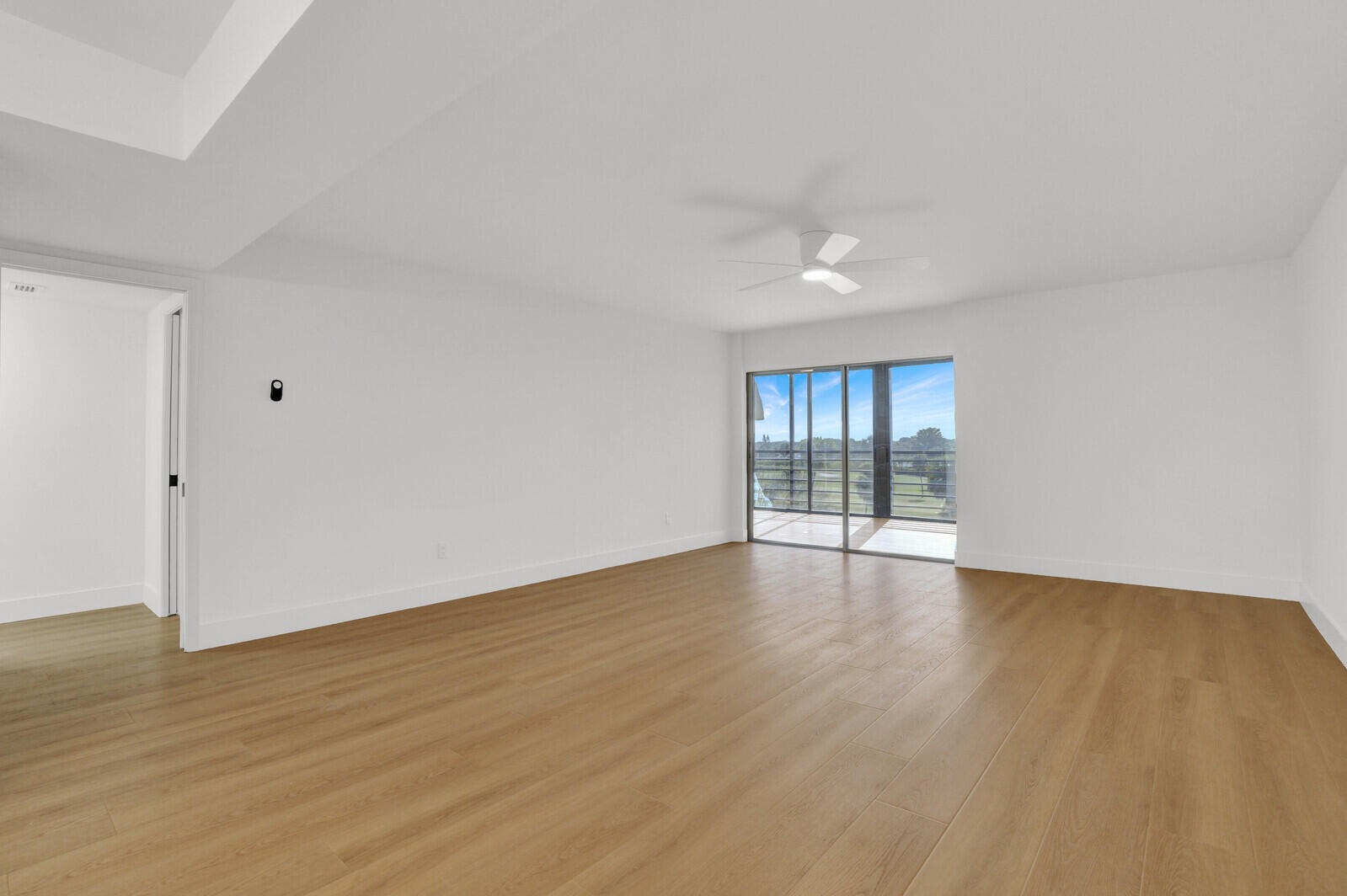 9260 Southwest 14th Street, Unit 2508 Boca Raton, FL 33428 - Photo 4 of 49 a view of an empty room with wooden floor and a window