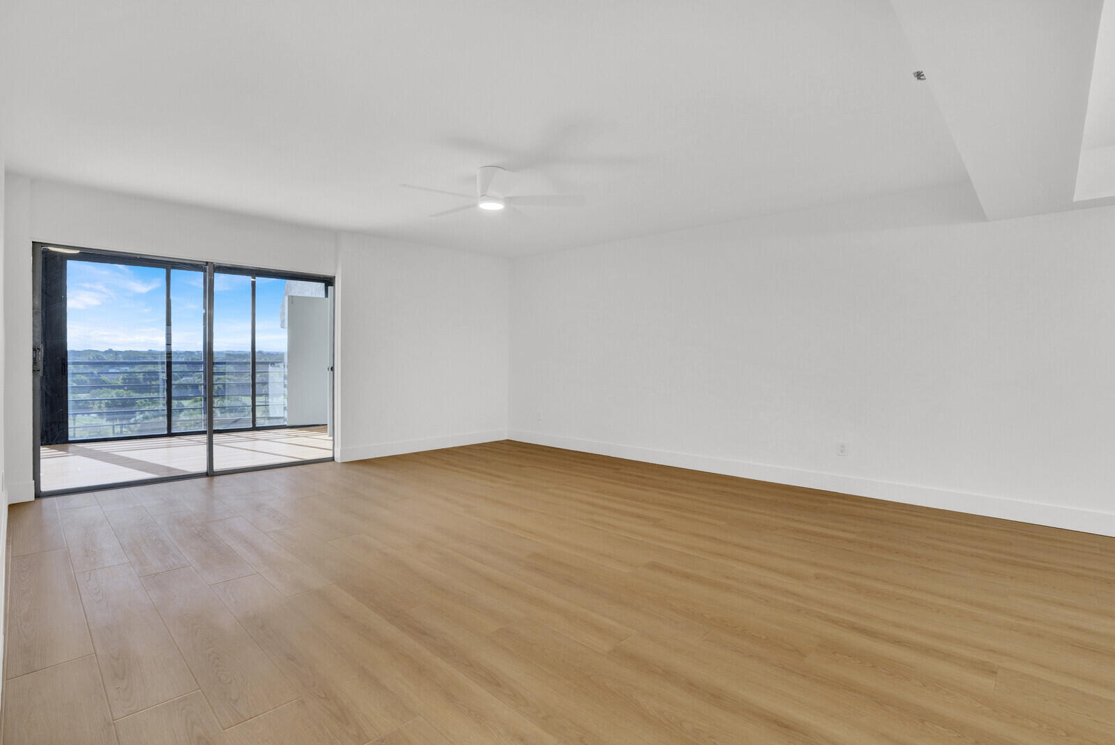9260 Southwest 14th Street, Unit 2508 Boca Raton, FL 33428 - Photo 6 of 49 a view of an empty room with wooden floor and a window