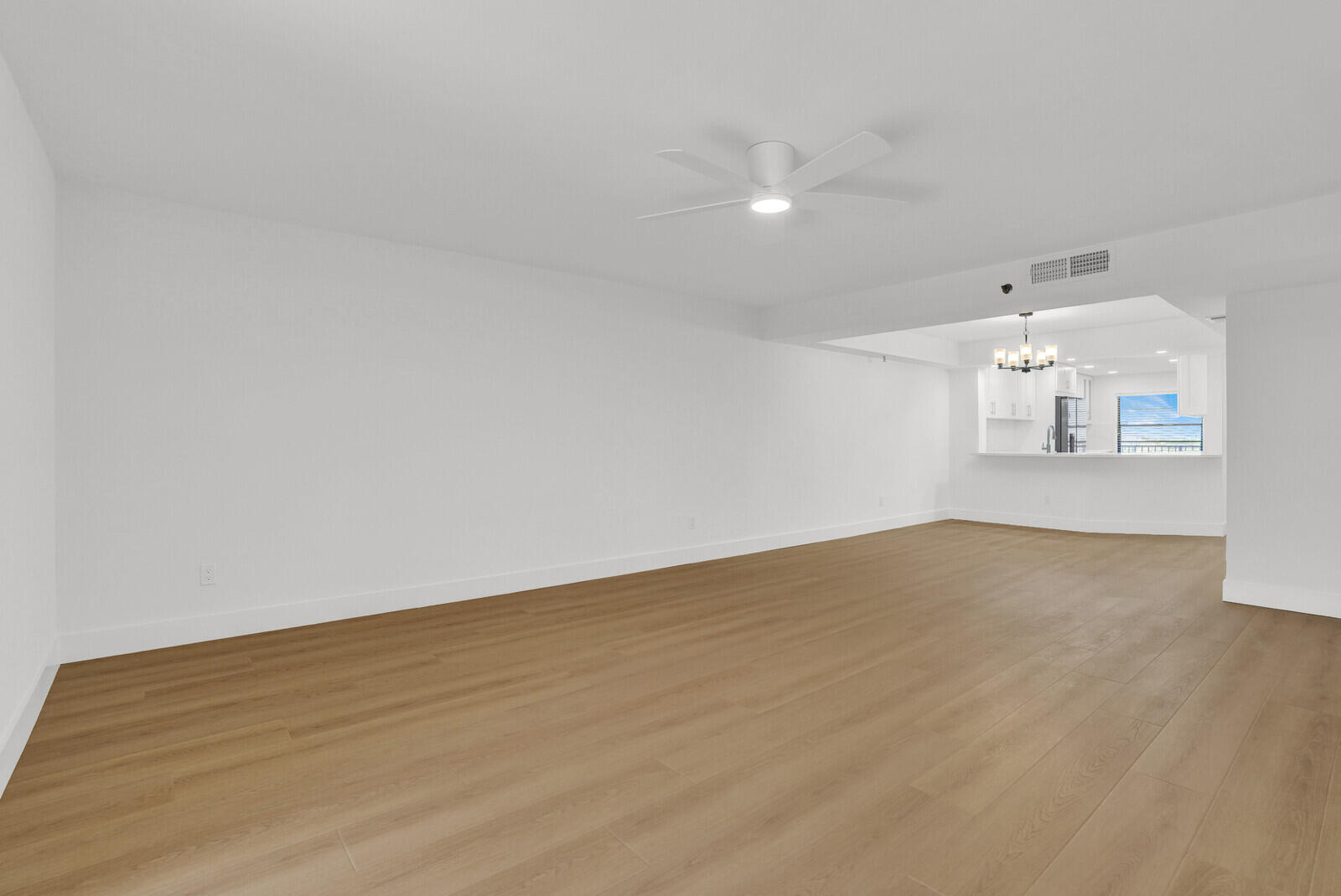 9260 Southwest 14th Street, Unit 2508 Boca Raton, FL 33428 - Photo 7 of 49 a view of empty room with wooden floor and fan