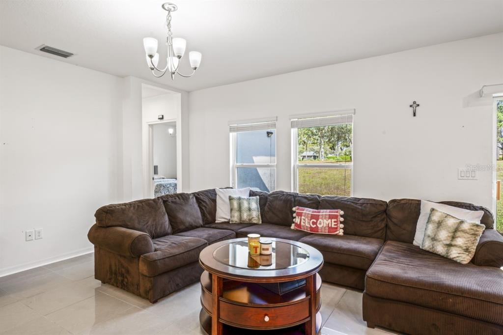 571 Old Windsor Way Spring Hill, FL 34609 - Photo 12 of 61 a living room with furniture and a window