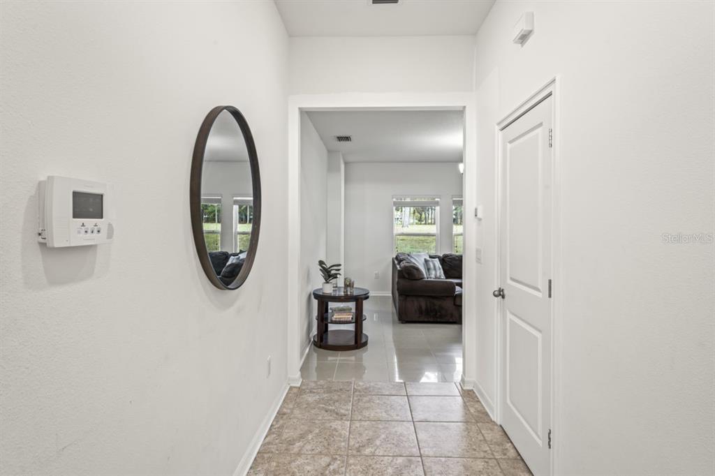 571 Old Windsor Way Spring Hill, FL 34609 - Photo 12 of 61 a view of a livingroom with furniture and a mirror
