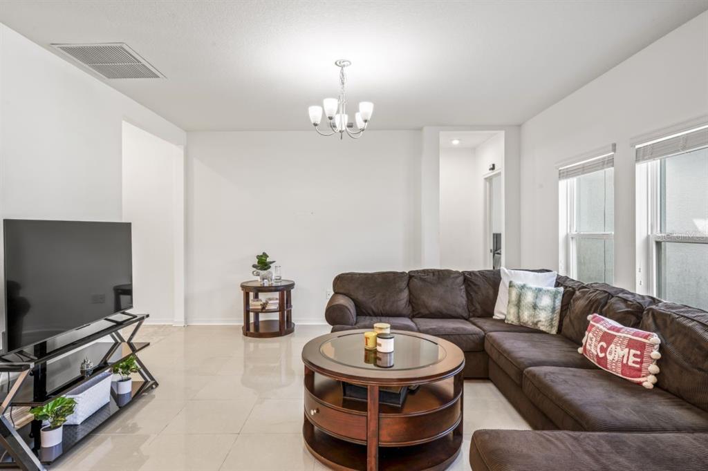 571 Old Windsor Way Spring Hill, FL 34609 - Photo 13 of 61 a living room with furniture and a flat screen tv