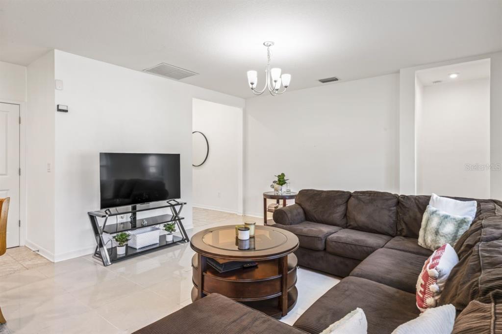 571 Old Windsor Way Spring Hill, FL 34609 - Photo 15 of 61 a living room with furniture and a flat screen tv