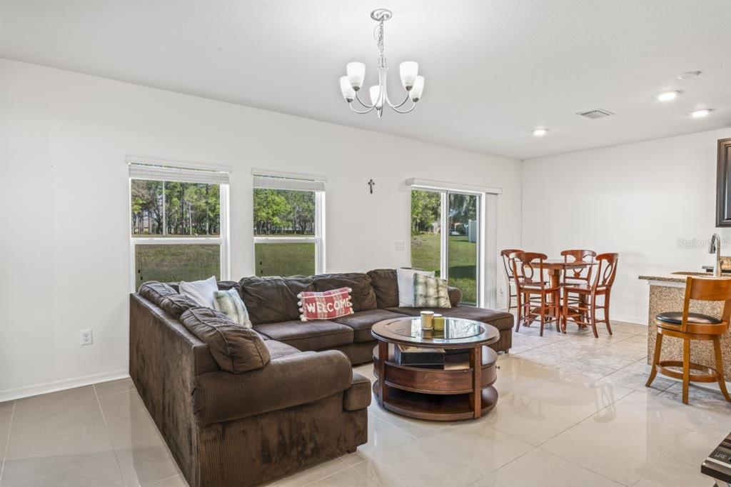 571 Old Windsor Way Spring Hill, FL 34609 - Photo 16 of 61 a living room with furniture and a large window