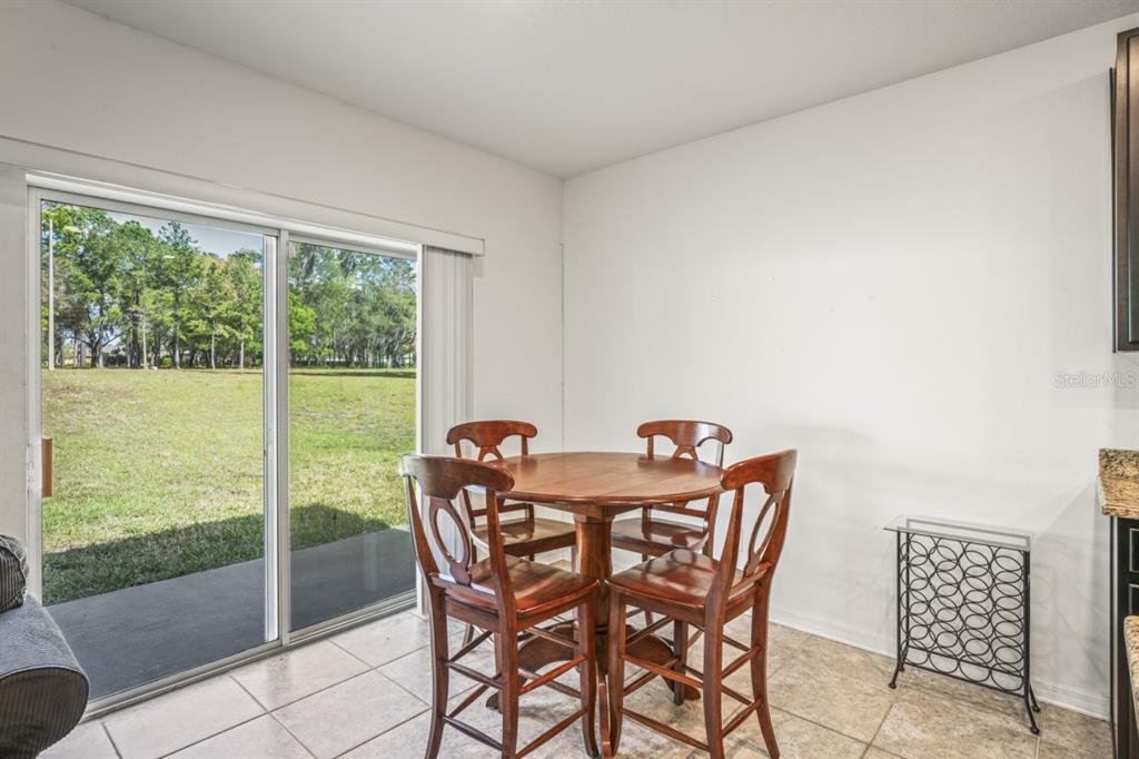 571 Old Windsor Way Spring Hill, FL 34609 - Photo 20 of 61 a view of a dining room with furniture window and outside view