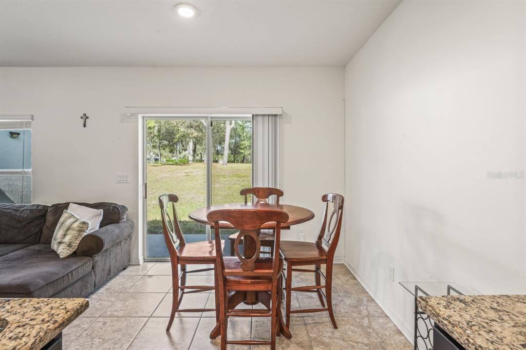 571 Old Windsor Way Spring Hill, FL 34609 - Photo 22 of 61 a dining room with furniture and a window