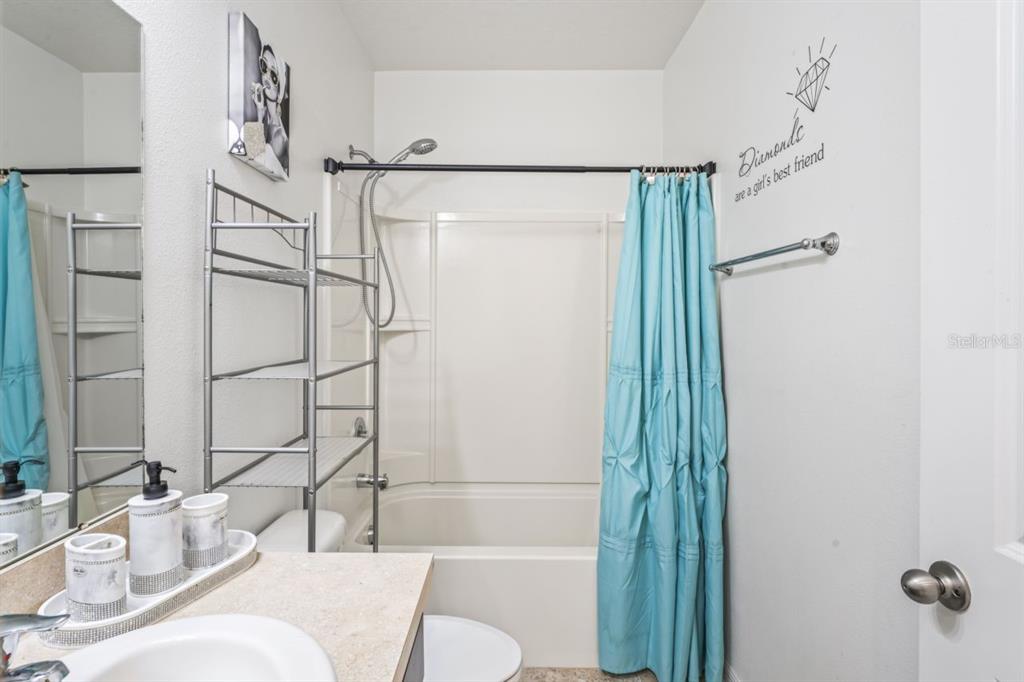 571 Old Windsor Way Spring Hill, FL 34609 - Photo 29 of 61 a bathroom with a sink and a mirror