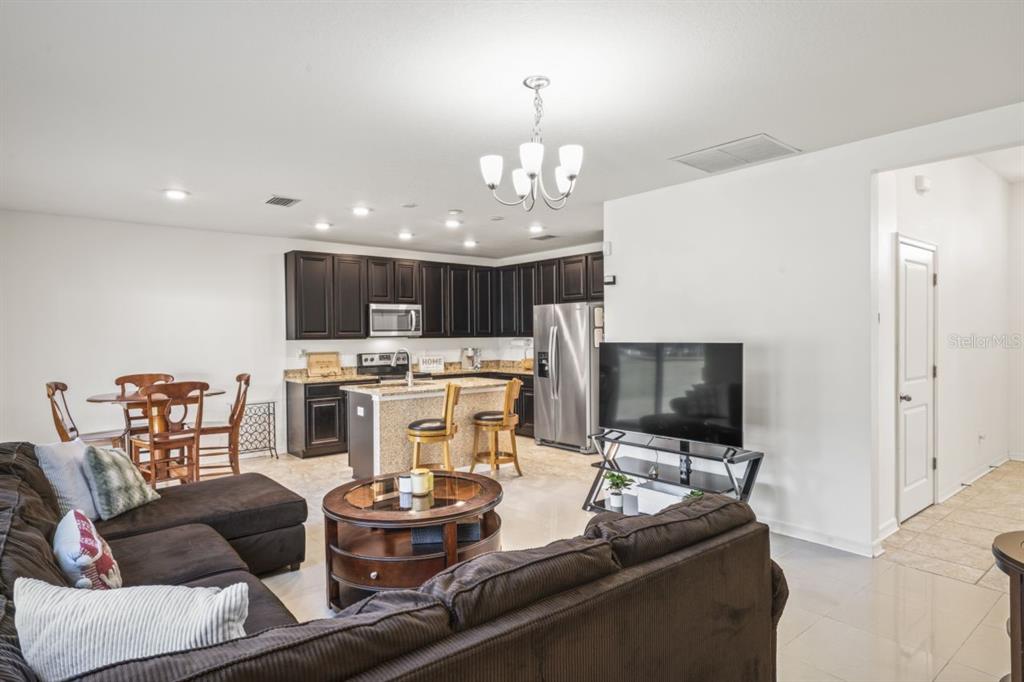 571 Old Windsor Way Spring Hill, FL 34609 - Photo 3 of 61 a living room with furniture and a flat screen tv